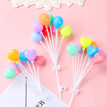 Cake topper në formë tullumbacesh