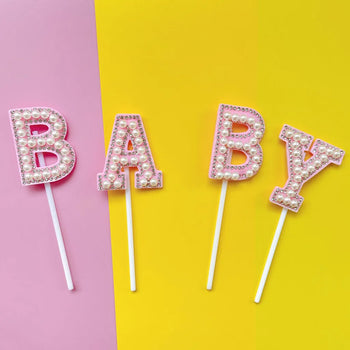 Cake topper me shkrim “Baby” e perla