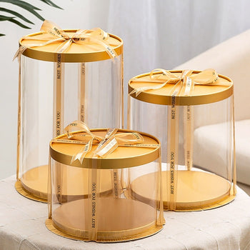 Kuti transparente rrethore për torta ose lule e dhurata me bazament në ngjyrën gold e kapak gold